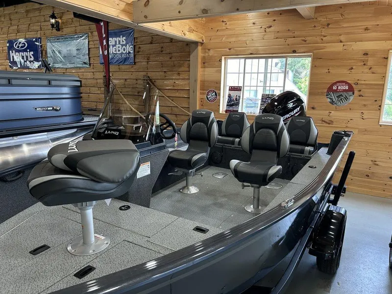 Slide: The Image of 2025 Lund Rebel XL 1650 XL SS fishing boat in showroom with seating and console. - 2