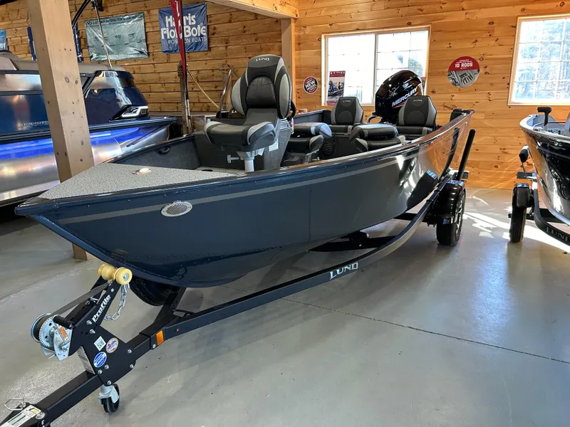 Slide: The Image of 2025 Lund Rebel XL 1650 XL SS fishing boat in showroom, sleek design, black finish. - 5