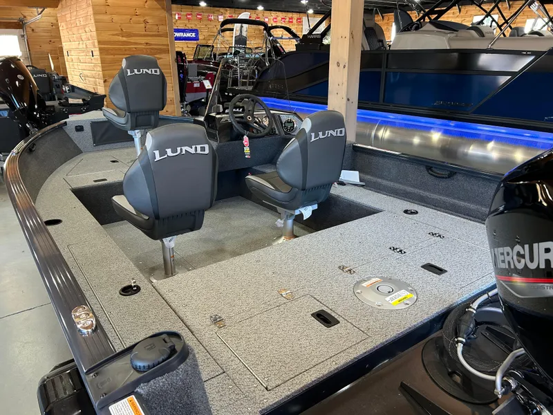 Slide: The Image of 2025 Lund Rebel XL 1650 XL SS boat interior with seating and storage compartments. - 7