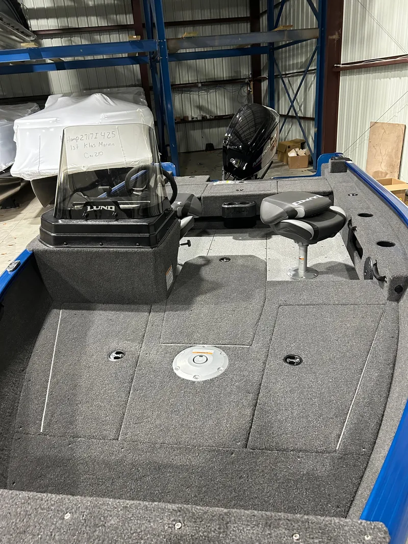 Slide: The Image of 2025 Lund ADVENTURE 1675 SS boat interior with steering console and seating. - 4