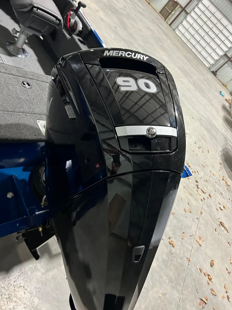 Slide: The Image of 2025 Lund ADVENTURE 1675 SS with Mercury 90 outboard motor in a garage. - 5