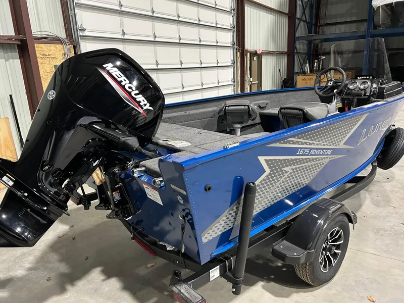 Slide: The Image of 2025 Lund ADVENTURE 1675 SS boat with Mercury engine in a garage. - 6