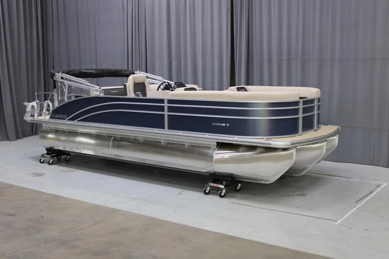 Slide: The Image of 2025 Harris CRUISER 230 SL pontoon boat in showroom setting. - 1