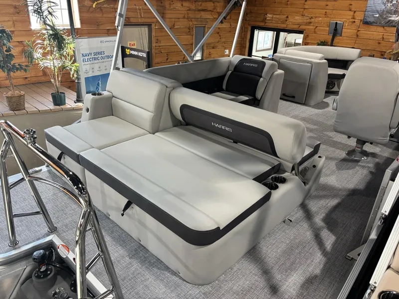 Slide: The Image of 2025 Harris Cruiser 210 SL boat interior with gray seating and modern design. - 11