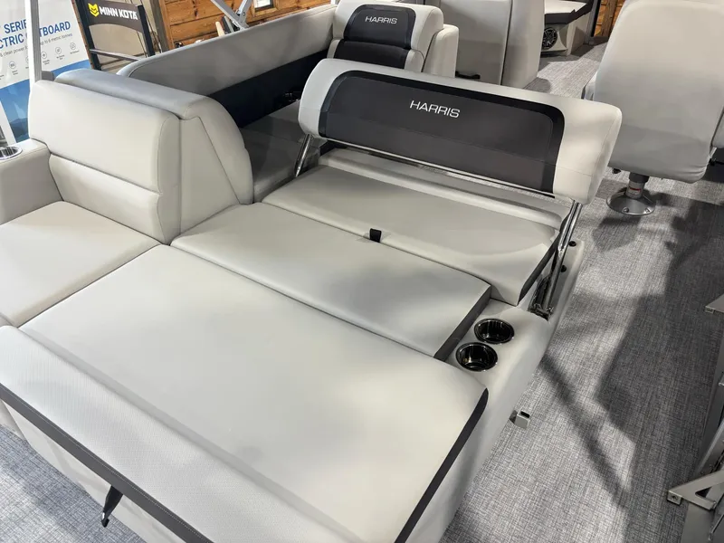 Slide: The Image of 2025 Harris Cruiser 210 SL boat interior with adjustable seating and cup holders. - 12
