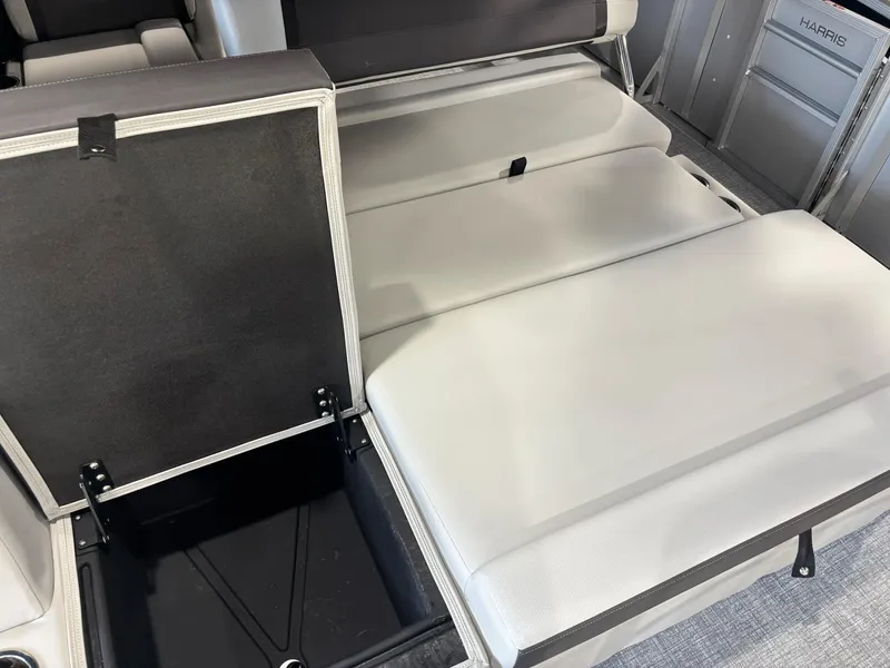 Slide: The Image of 2025 Harris Cruiser 210 SL interior seating with storage compartment open. - 13