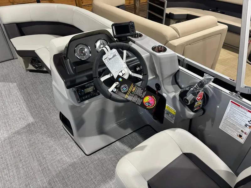Slide: The Image of 2025 Harris Cruiser 210 SL boat interior with modern steering console and seating. - 8