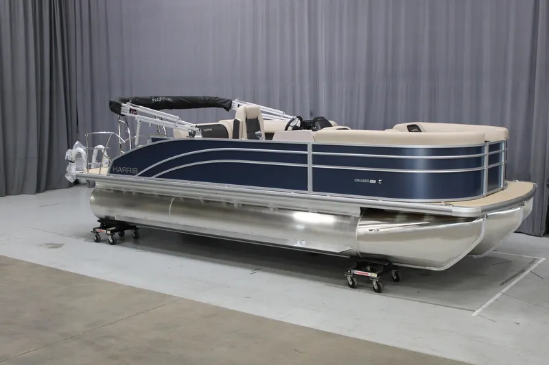 Slide: The Image of 2025 Harris Cruiser 210 SL pontoon boat in showroom, featuring sleek design and modern amenities. - 5
