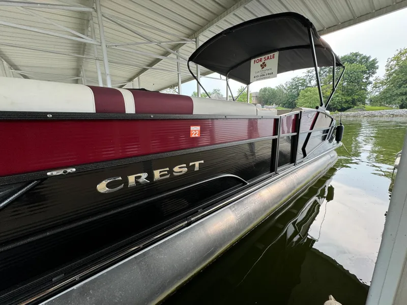 The Image of 2019 Crest Caribbean 250 SLRC pontoon boat for sale under covered dock. - 0