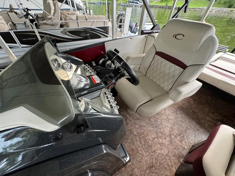 Slide: The Image of 2019 Crest Caribbean 250 SLRC boat interior with steering console and luxurious seating. - 7