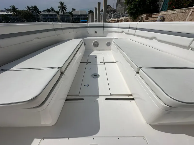 Slide: The Image of 2015 Intrepid 400 Center Console boat interior with white seating and spacious deck. - 11