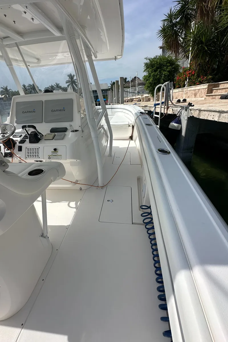 Slide: The Image of 2015 Intrepid 400 Center Console boat with sleek white deck and modern controls. - 16