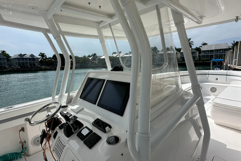 Slide: The Image of 2015 Intrepid 400 Center Console boat interior with dual screens and steering wheel. - 17