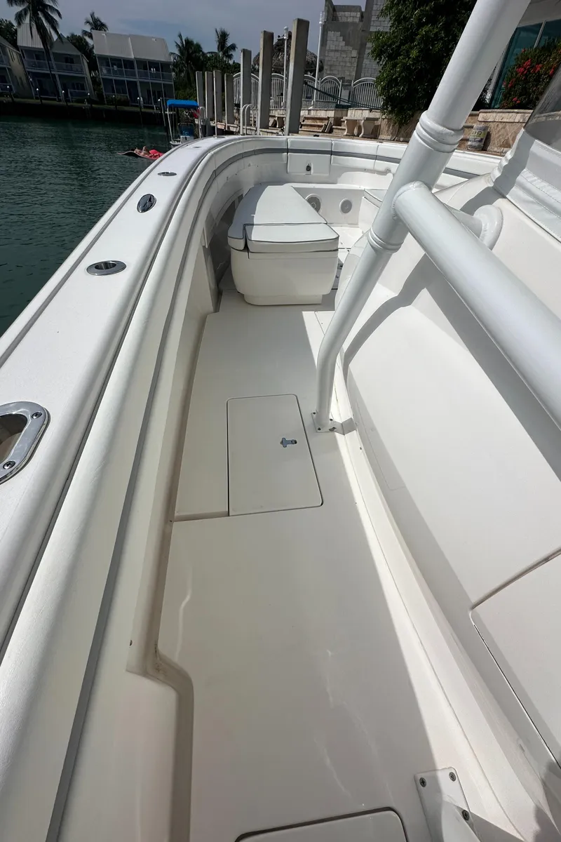 Slide: The Image of 2015 Intrepid 400 Center Console boat deck with seating, docked by waterfront homes. - 18