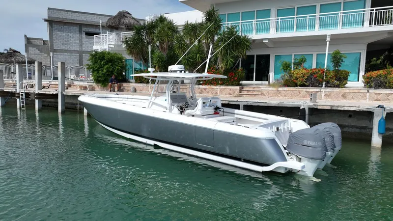 Slide: The Image of 2015 Intrepid 400 Center Console boat docked by waterfront home. - 2