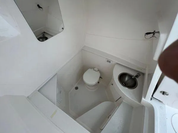 Slide: The Image of 2015 Intrepid 400 Center Console boat bathroom with toilet and sink. - 22