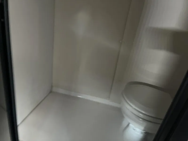 Slide: The Image of Interior of 2013 Baja 35 Outlaw boat bathroom with toilet. - 10
