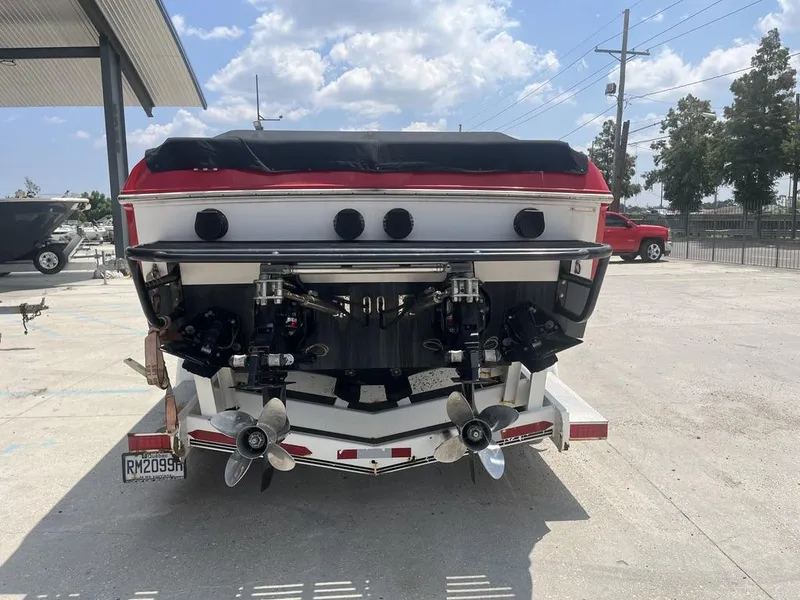 Slide: The Image of 2013 Baja 35 Outlaw boat rear view with dual propellers on trailer. - 11