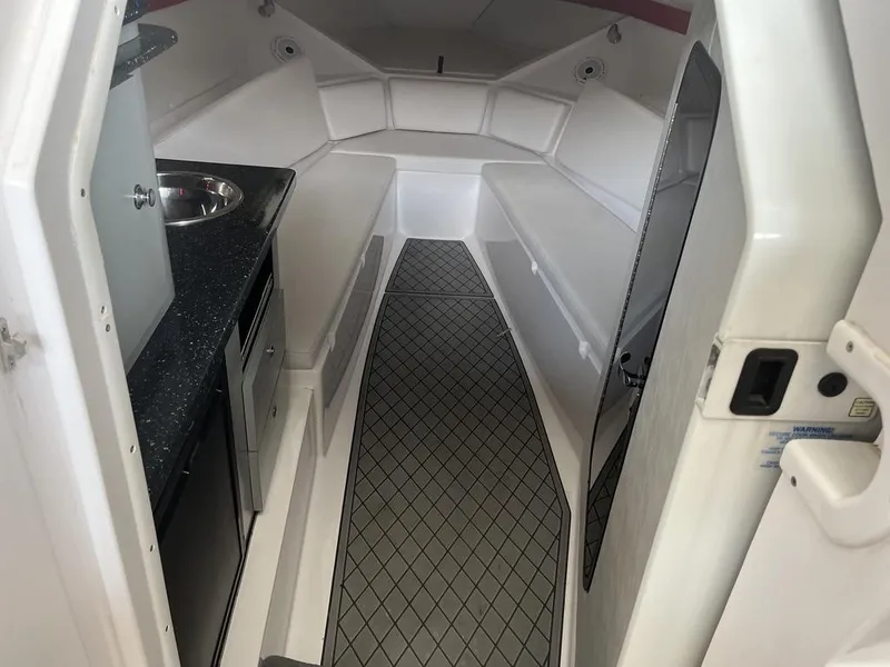 Slide: The Image of Interior of 2013 Baja 35 Outlaw boat with kitchenette and seating area. - 14