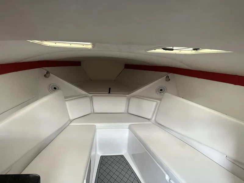 Slide: The Image of Interior of 2013 Baja 35 Outlaw boat with white seating and red accents. - 15