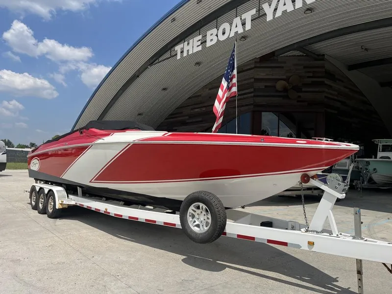 Slide: The Image of 2013 Baja 35 Outlaw boat on trailer at boat yard, American flag displayed. - 3