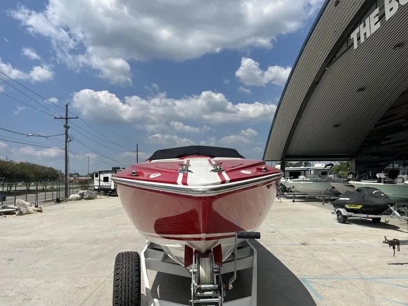 Slide: The Image of 2013 Baja 35 Outlaw boat on trailer under cloudy sky. - 4