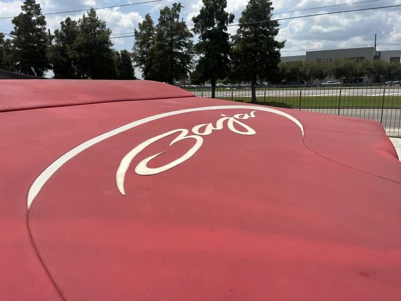 Slide: The Image of Red Baja 35 Outlaw boat cover with logo, 2013 model, outdoors. - 6