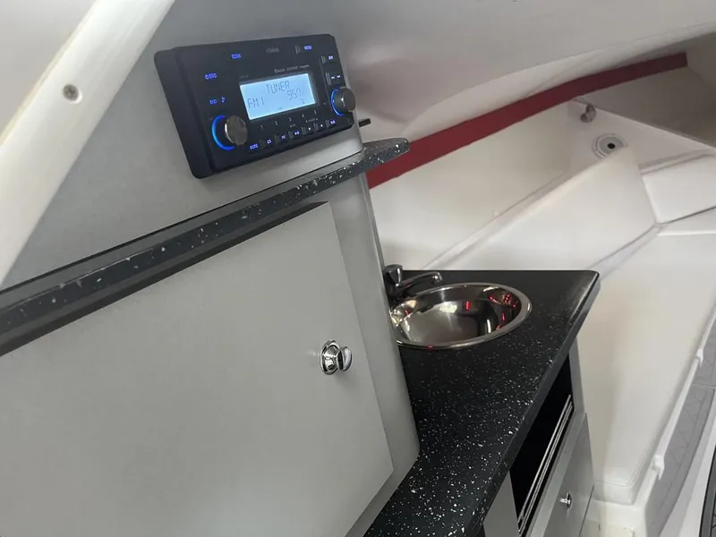 Slide: The Image of Interior of 2013 Baja 35 Outlaw boat with radio and sink. - 8