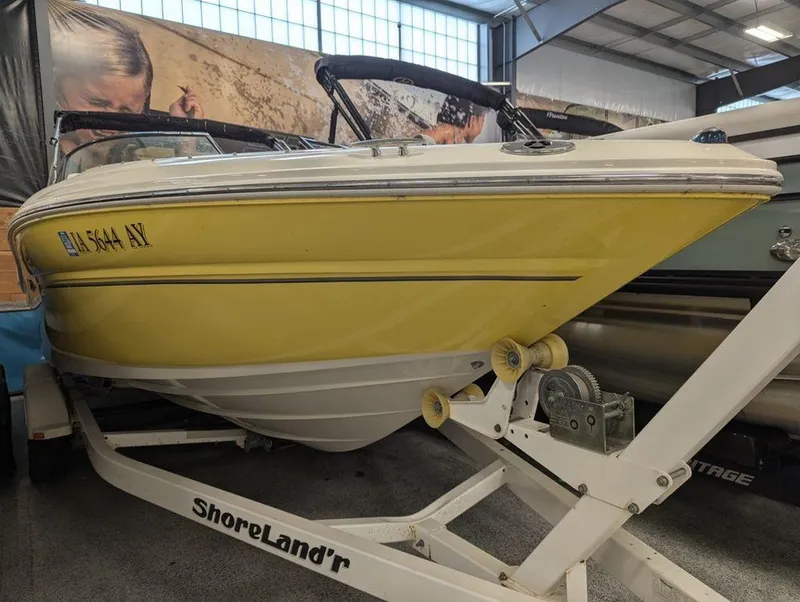 Slide: The Image of 2005 Sea Ray 240 SEL boat on ShoreLand'r trailer in indoor storage. - 2