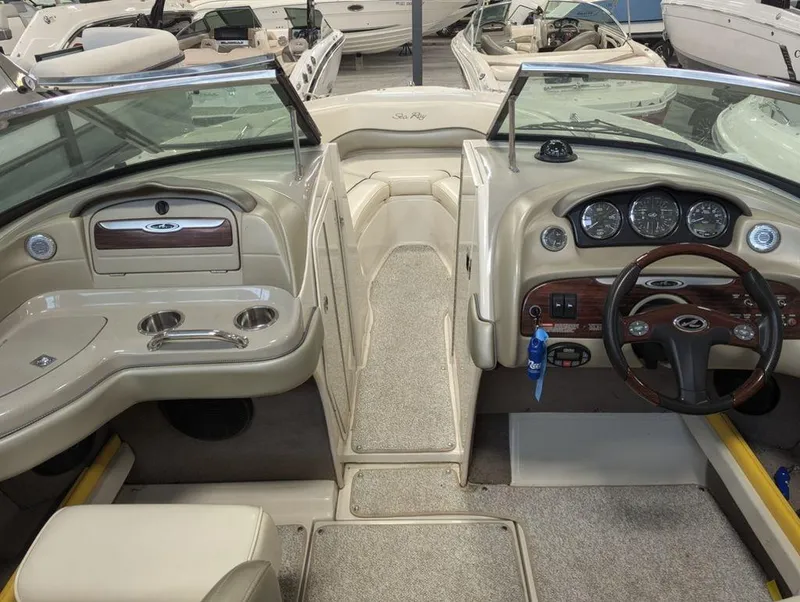Slide: The Image of Interior of a 2005 Sea Ray 240 SEL boat with dashboard and seating area. - 4