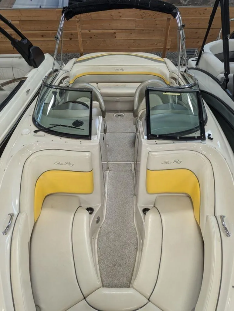 Slide: The Image of 2005 Sea Ray 240 SEL boat interior with yellow and cream seating. - 6