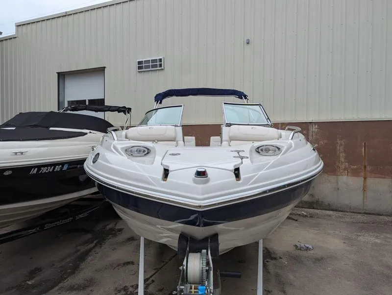 Slide: The Image of 2009 Crownline 240 LS boat parked outside a warehouse. - 1