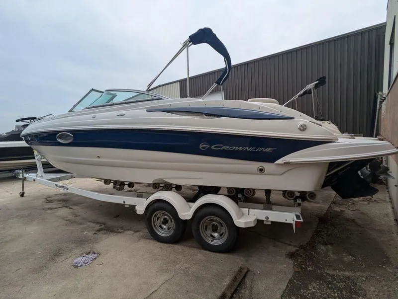 Slide: The Image of 2009 Crownline 240 LS boat on trailer, parked outdoors. - 3