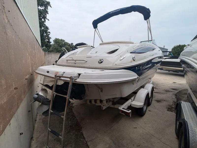 Slide: The Image of 2009 Crownline 240 LS boat on trailer, parked outdoors. - 4