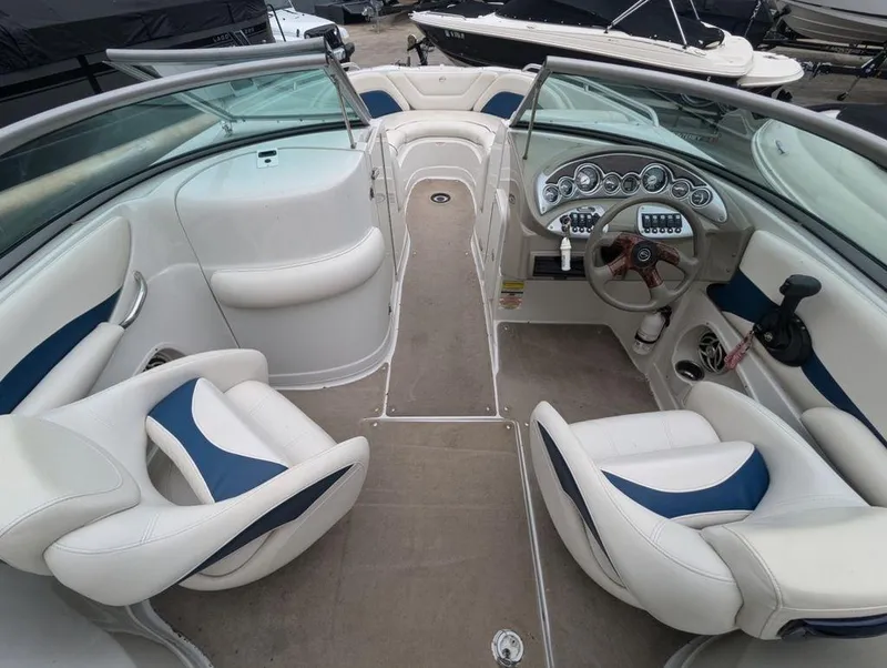 Slide: The Image of Interior of a 2009 Crownline 240 LS boat with white and blue seating. - 7