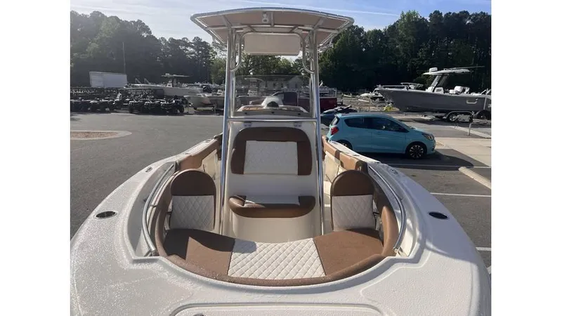 Slide: The Image of 2025 Pioneer 202 Islander boat with spacious seating and modern design in a parking lot. - 4