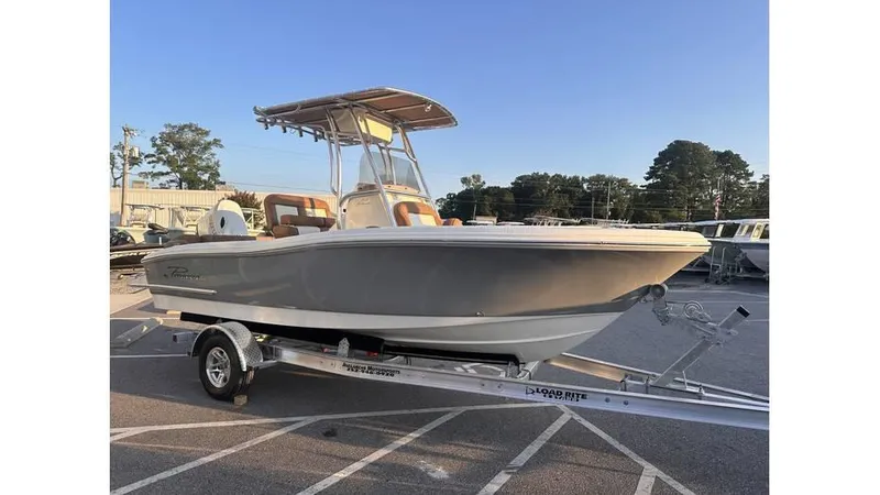 Slide: The Image of 2025 Pioneer 202 Islander boat on trailer in parking lot, side view. - 5