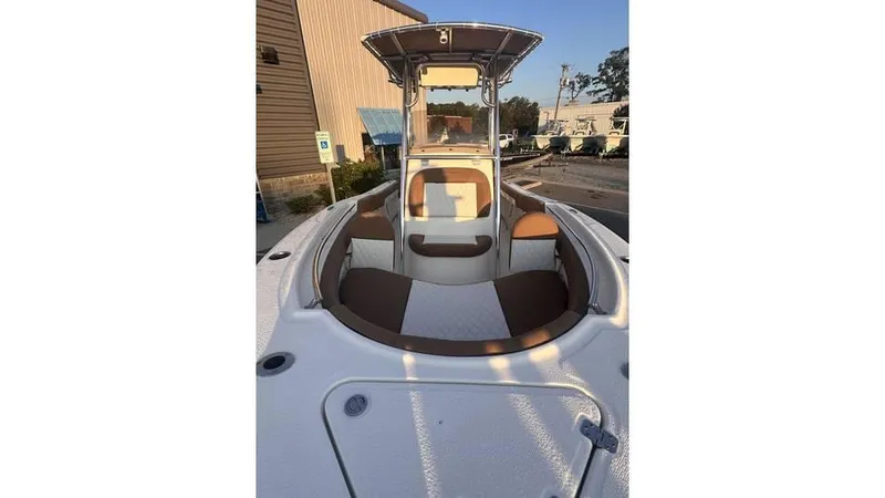 Slide: The Image of 2025 Pioneer 202 Islander boat with seating, docked outdoors. - 6