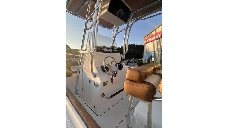 Slide: The Image of 2025 Pioneer 202 Islander boat interior with steering console and seating. - 7