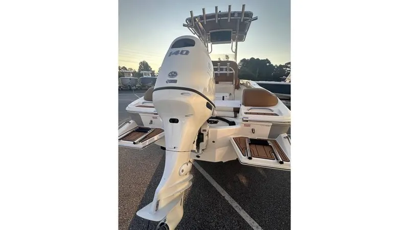 Slide: The Image of 2025 Pioneer 202 Islander boat with powerful outboard motor, docked at sunset. - 9