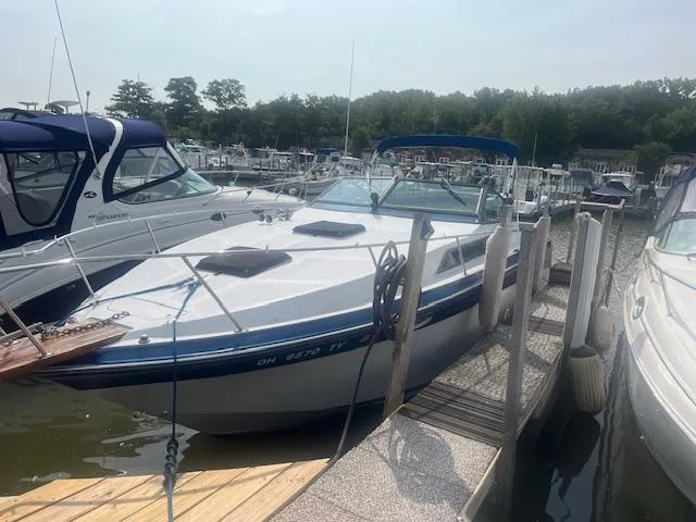 Slide: The Image of 1988 Regal 277 Commodore XL docked at a marina, surrounded by other boats. - 1