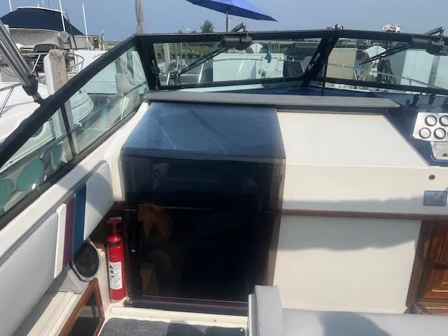 Slide: The Image of 1988 Regal 277 Commodore XL boat interior with dashboard and fire extinguisher. - 10