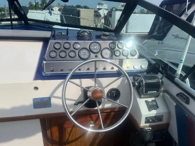 Slide: The Image of 1988 Regal 277 Commodore XL boat dashboard with steering wheel and instrument panel. - 11