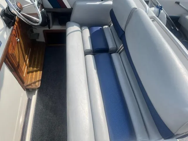 Slide: The Image of 1988 Regal 277 Commodore XL boat interior with blue and gray seating. - 12