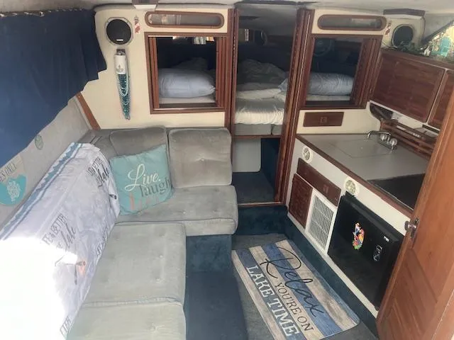 Slide: The Image of Interior of 1988 Regal 277 Commodore XL boat with cozy seating and compact kitchen area. - 15