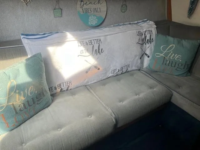 Slide: The Image of Cozy interior of 1988 Regal 277 Commodore XL with decorative pillows and lake-themed decor. - 17