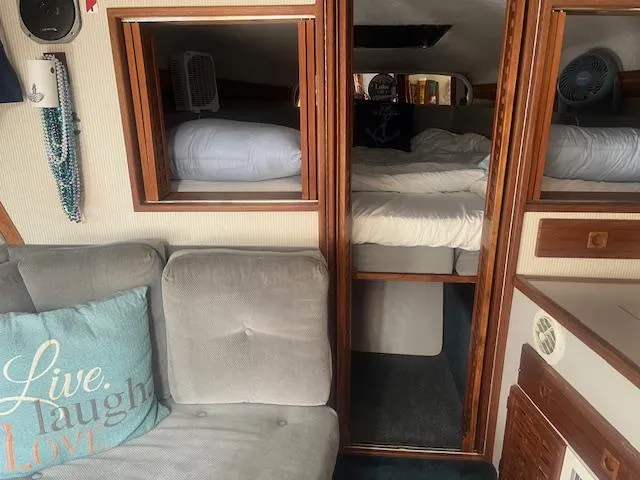 Slide: The Image of Interior of 1988 Regal 277 Commodore XL boat with cozy seating and sleeping area. - 18