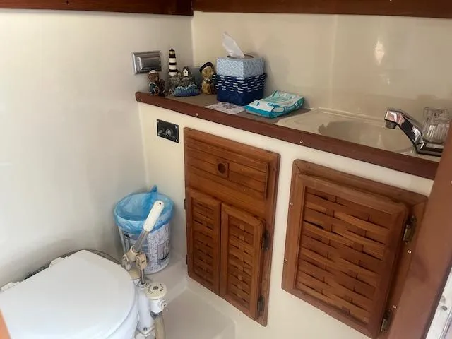 Slide: The Image of 1988 Regal 277 Commodore XL boat bathroom with wooden cabinets and sink. - 23