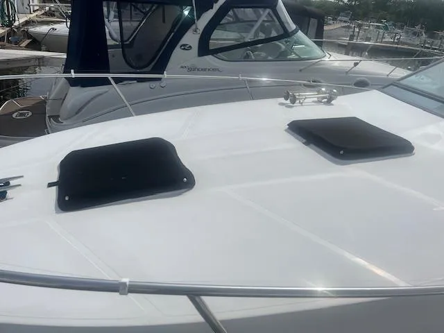 Slide: The Image of 1988 Regal 277 Commodore XL boat deck with hatches, docked at marina. - 4