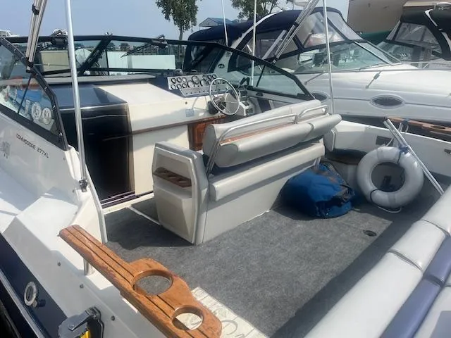 Slide: The Image of 1988 Regal 277 Commodore XL boat interior with seating, steering wheel, and life preserver. - 8